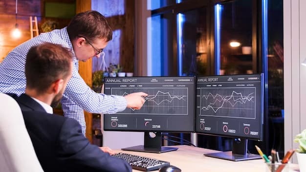 Two men working on a computer and communicating