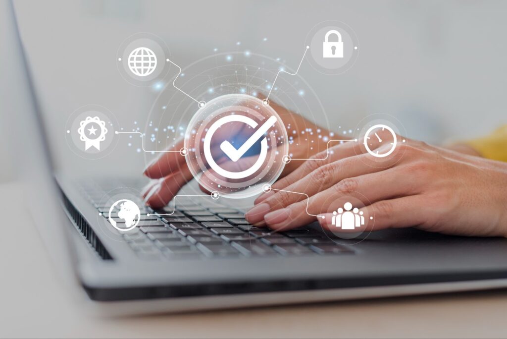 Close up of hands typing on laptop with cloud security concept